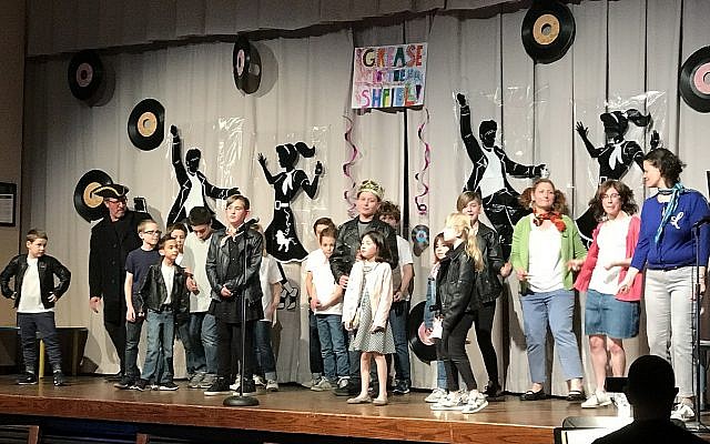 Students from Temple Emanuel and Beth El Congregaton perform a parody of “Grease” for Purim. (Photo by Rob Goodman)