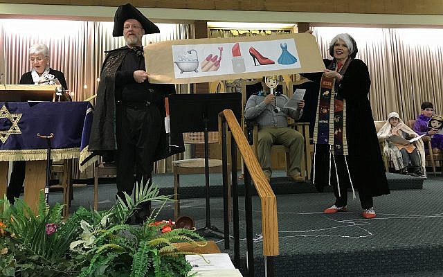 Ben Vincent and Cantor Michal hold a scroll showing, in emojis, the beauty treatments available to the maidens competing to be the Queen of Persia at Congregation B’nai Abraham. Also pictured, from left, are Shirley Grossman, David Perelman, Ethan Binus and Helene Grossman. Photo courtesy of Cantor Michal Gray-Schaffer