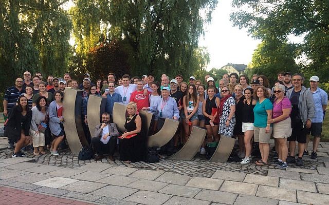 Educators, students and lay leaders on a 2017 trip to Poland with Classrooms Without Borders, one of many trips that organizations lead to Poland from Pittsburgh. The group poses for a photo in the town of Kielce, Poland. (Photo by Jahee Cho)