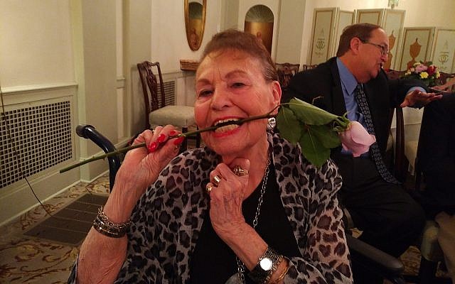 Thelma Gold Landay cheerily bites down on a rose that was given to her during the Steeltown Entertainment Project's celebration of mothers. (Photo by Adam Reinherz)