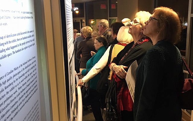 Patrons peruse David Rosenberg’s research on the exhibit’s opening day. (Photo by Lydia Rosenberg)