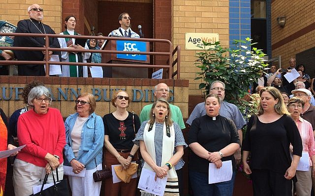 Area clergy gather in front of the JCC, singing "We Shall Overcome" in a demonstration organized by the JCC's  Center for Loving Kindness and Civil Engagement, and Christian Associates of Southwest Pennsylvania. (Photo by Toby Tabachnick)