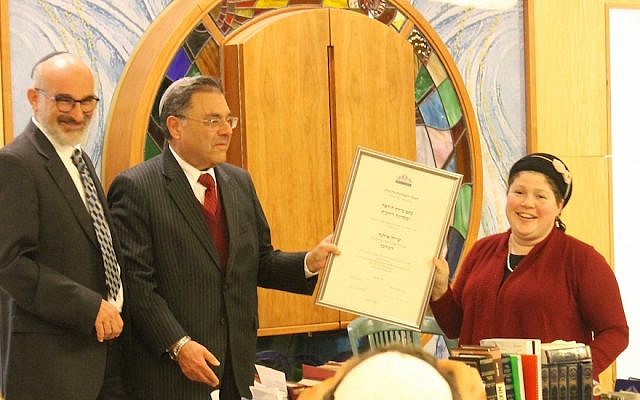Rabbi Shlomo Riskin, chancellor of Ohr Torah Stone, presents Rabbanit Shira Zimmerman with her certification as a spiritual leader and arbiter of Jewish law at a ceremony in Jerusalem, Jan. 3. 2017. (Photo courtesy of Ohr Torah Stone)