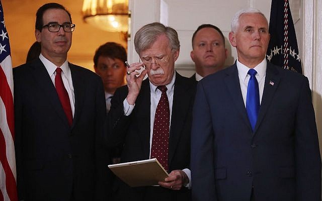 White House National Security Advisor John Bolton, center, flanked by Treasury Secretary Steven Mnuchin, left, and Vice President Mike Pence, listening to President Donald Trump announcing his decision to withdraw the U.S. Iran nuclear deal in the Diplomatic Room at the White House, May 8, 2018. (Photo by Chip Somodevilla/Getty Images)