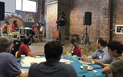 Richard Garland, director of the Violence Prevention Initiative, a local nonprofit based at the University of Pittsburgh, speaks to attendance members at Monday's gun violence community roundtable event at Repair the World Pittsburgh. (Photo by  Sara Tyberg)