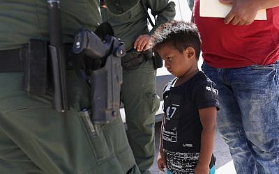 A boy from Honduras is shown being taken into custody by U.S. Border Patrol agents near the U.S.-Mexico Border near Mission, Texas, June 12, 2018. (Photo by John Moore/Getty Images)