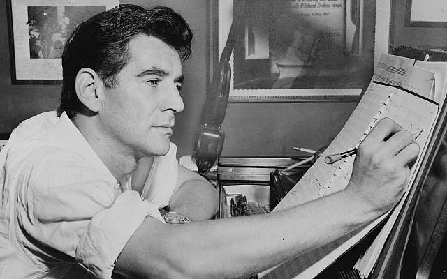 Leonard Bernstein seated at piano, making annotations to musical score in 1955. (Photo by Al Ravenna, World Telegram staff photographer, courtesy of Wikimedia Commons)