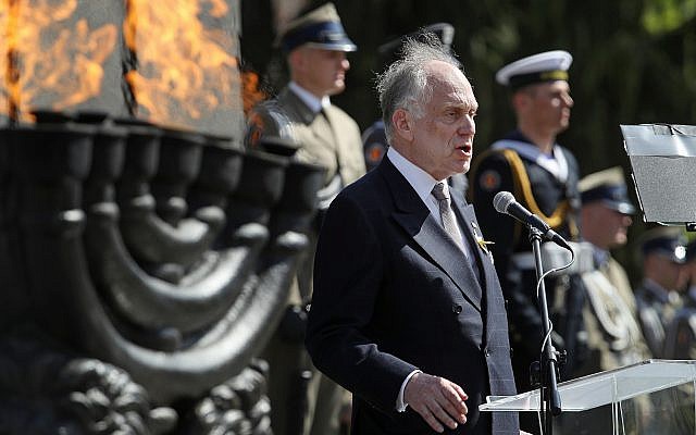 Ronald Lauder speaking next to a lit menorah at a memorial to the Warsaw Ghetto Uprising in Poland, April 19, 2018. (Photo by Sean Gallup/Getty Images)