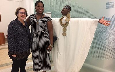 Leslie Golomb (left), poses with sculptor Dominique Scaife and Scaife's piece, "Serenity." (Photo by Toby Tabachnick.)