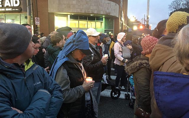 Jewish community members join other Pittsburgh residents to mourn the loss of 11 lives murdered at Tree of Life*Or L’Simcha at the first of several vigils in the Squirrel Hill section of the city.  (Photo by Jim Busis)