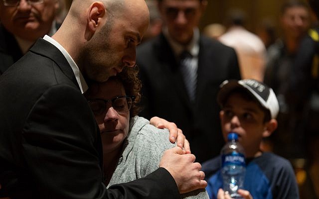 People comfort one another during a vigil for the Tree of Life victims at the Soldiers & Sailors Memorial Hall on Sunday, Oct. 28, 2018. (Photo by Joshua Franzos)