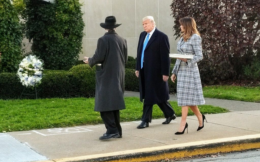 Rabbi Hazzan Jeffrey Myers leads President President Donald Trump and First Lady Melania Trump toward the makeshift memorial outside the Tree of Life building. Photo by Adam Reinherz
