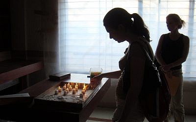 An AJC delegation lights yahrzeit candles at Mumbai’s Chabad House in 2010, two years after the terror attack.
(Photo by Jim Busis)
