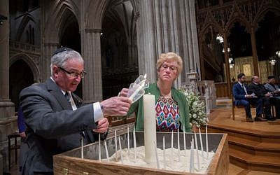 Alan and Stacey Hausman light a candle inside the Washington National Cathedral. Photo courtesy of Stacey Hausman