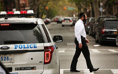NEW YORK, NY - APRIL 24:  A Hasidic man walks by a police car in a Jewish Orthodox neighborhood in Brooklyn on April 24, 2017 in New York City. According to a new report released by the Anti-Defamation League (ADL), anti-Semitic incidents in the U.S. rose by 86 percent in the first three months of the year. The group's audit of anti-Semitic events counted 541 anti-Semitic attacks and threats in the first quarter of the year, a significant increase over the same period last year.  (Photo by Spencer Platt/Getty Images)