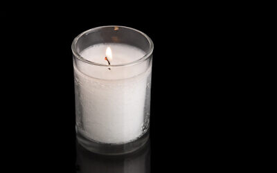 A custom in Judaism is to kindle a light on the anniversary of the death of a loved one. This special light is traditionally a thick wax candle held inside a clear, glass jar. Photo by leah613 / via Istockphoto.com