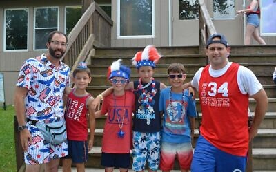 Director of Emma Kaufmann Camp, Aaron Cantor (left), campers and  Brooks Weaver, EKC's assistant camp director on July 4, 2019. (Photo provided by Aaron Cantor)