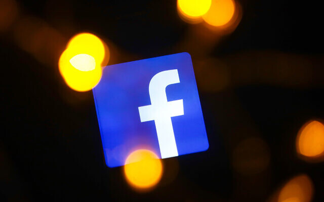 Facebook logo is displayed on a mobile phone screen (Photo by Beata Zawrzel/NurPhoto via JTA)
