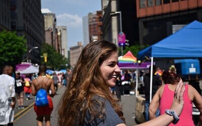Laura Cherner, assistant director, Community Relations Council, waves to the crowd as she works to support Jewish community participants in the Pittsburgh Pride parade in early 2018. Photo courtesy of Jewish Federation of Greater Pittsburgh