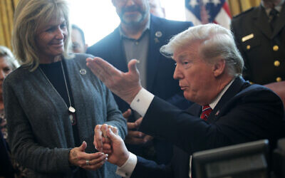 President Donald Trump greets Mary Ann Mendoza during an event on border security in the Oval Office of the White House, March 15, 2019. (JTA/Alex Wong/Getty Images)