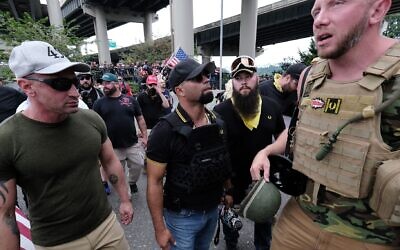 Far-rightists from the Proud Boys wait to get into vehicles after marching across the Hawthorne Bridge in Portland, Ore., Aug. 17, 2019. (Alex Milan Tracy/Anadolu Agency via Getty Images via JTA)