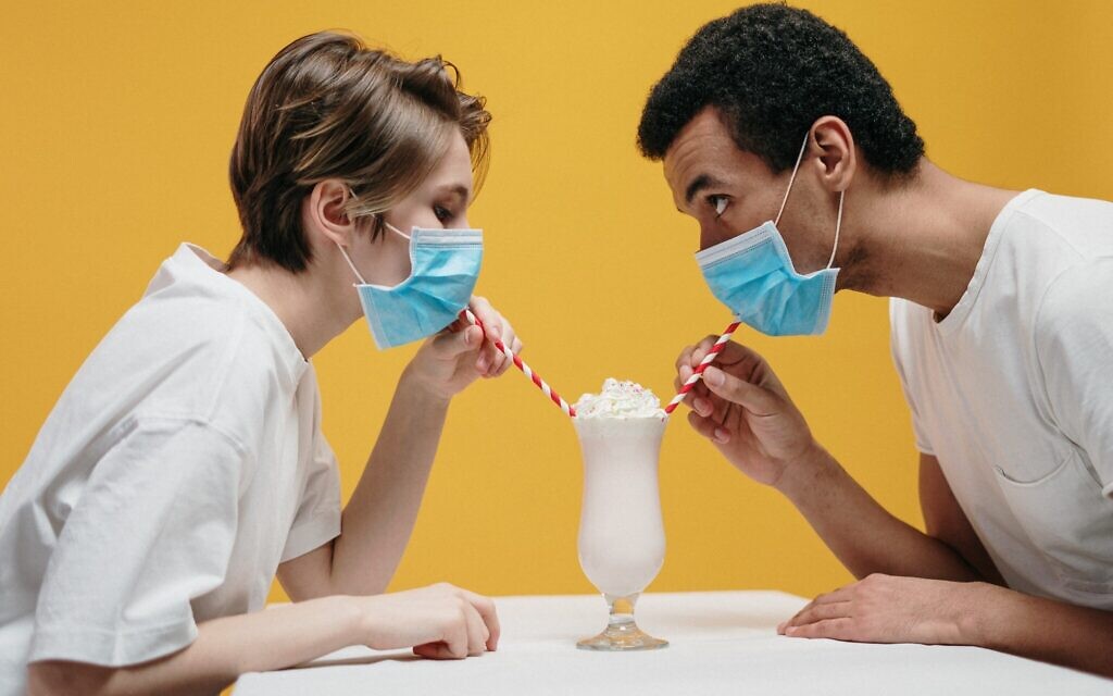 Couple wearing face masks and drinking a milkshake (Photo by cottonbro via Pexels) Couple wearing face masks and drinking a milkshake (Photo by cottonbro via Pexels)