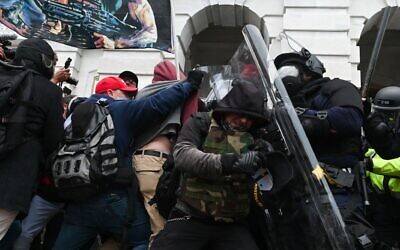 Riot police push back a crowd of supporters of US President Donald Trump after they stormed the Capitol building in Washington, DC on Jan. 6, 2021. (Roberto Schmidt AFP via Getty Images via JTA)