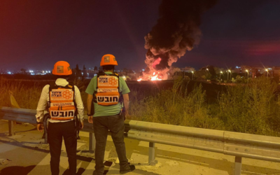 Paramedics observe a fire in Ramle caused by a rocket from Gaza that landed in the city, May 13, 2021. (United Hatzalah via The Times of Israel)