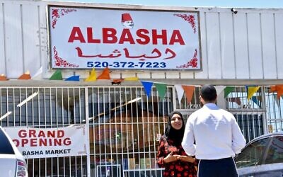 Ghufran Almusawi speaks with a Jewish customer (Photo by Michael Zaccaria/Keeping Jewish via Jewish News)