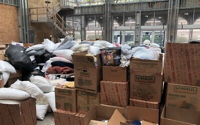 A social hall under construction in The Shul, a synagogue in Surfside, Fla., is piled high with donations for homeless families less than 18 hours after a nearby building collapsed, June 25, 2021. (Ron Kampeas/JTA)