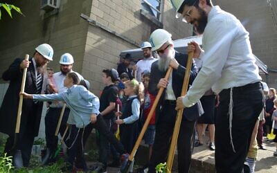 Members of the Greenfield Jewish community recently participated in the ground breaking of new mikvahs at Bnai Emunah Chabad . Photo by Yehuda Welton.