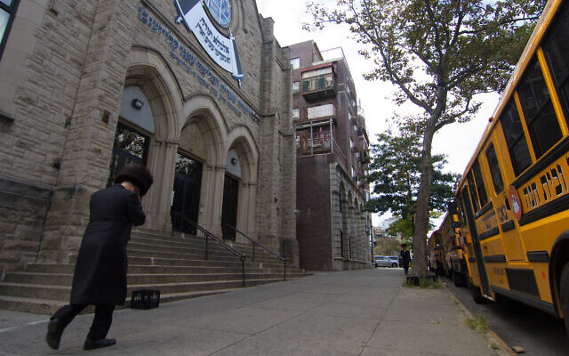 A man walks past an Orthodox yeshiva in Brooklyn, Sept. 29, 2020. (Daniel Moritz-Rabson)