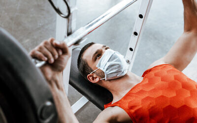 Mask wearing while working out. Photo by LightFieldStudios via iStock