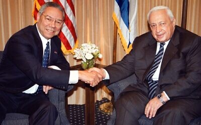 U.S. Secretary of State Colin Powell, left, shakes hands with Israeli Prime Minister-elect Ariel Sharon in Jerusalem on Feb. 25, 2001. (Getty Images/Pool photo via JTA)