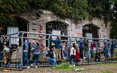 Participants at the Festival of Resilience in Berlin build a sukkah. (Photo by Debi Simon for Hillel Deutschland)