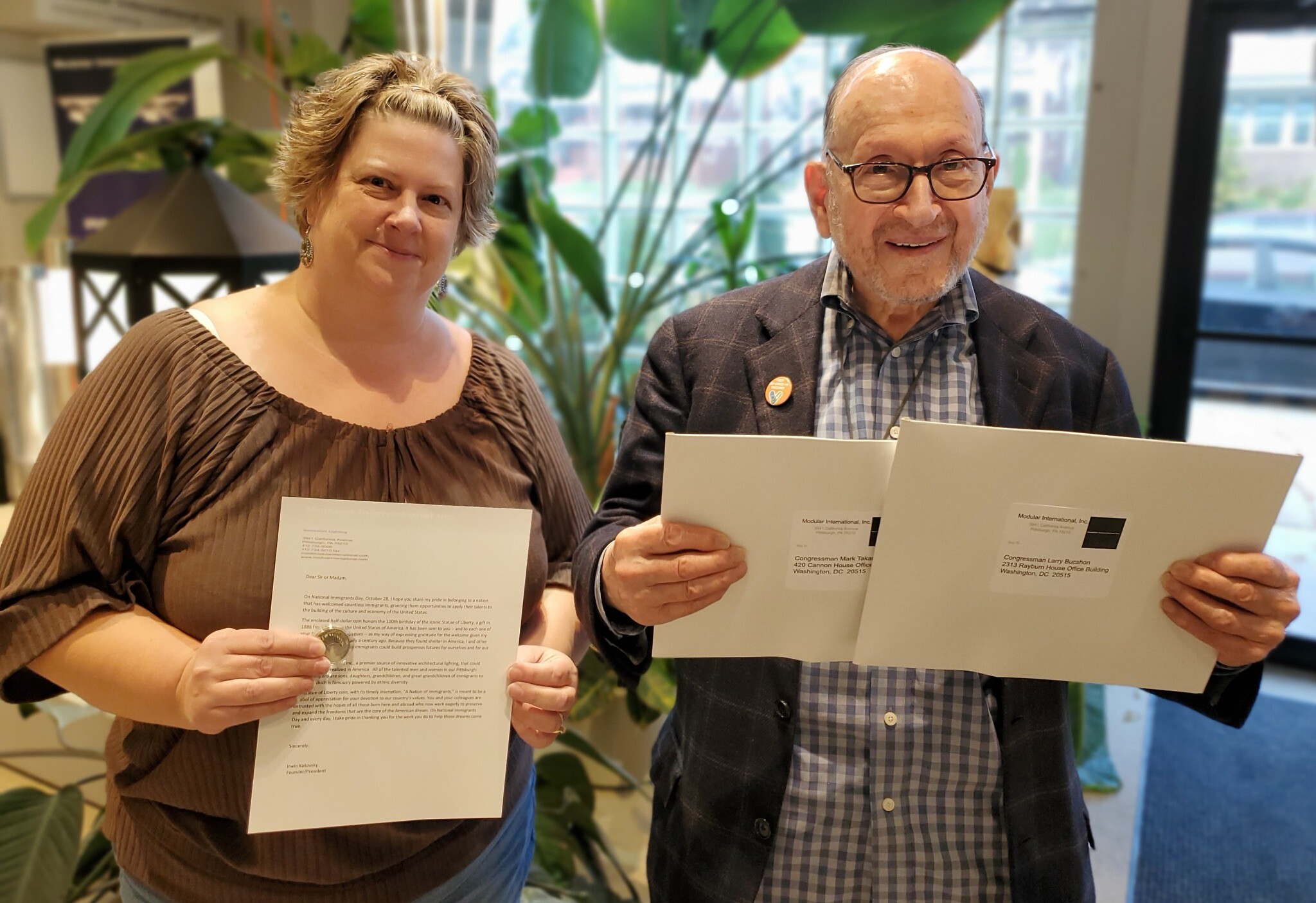 Tracy Kosylo and Irwin Kotovsky hold a commemorative coin, letter and envelopes. Photo by Adam Reinherz Tracy Kosylo and Irwin Kotovsky hold a commemorative coin, letter and envelopes. Photo by Adam Reinherz