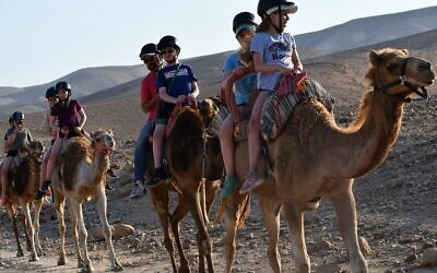 CDS students ride camels in the Judean Desert during their eighth-grade trip in 2018 (Photo courtesy of Community Day School)