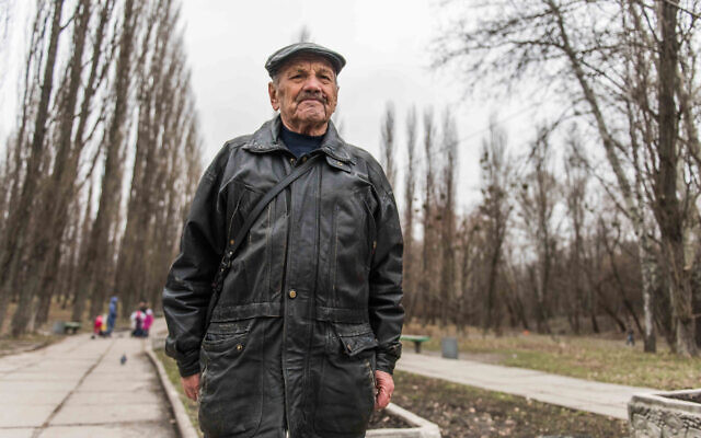 Vladimir Proch, a Holocaust survivor and Claims Conference recipient, visits a memorial monument in Kiyv, Ukraine on March 14, 2016. (Photo Cnaan Liphshiz)