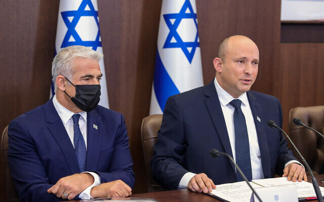 Yair Lapid and Prime Minister Naftali Bennett during a cabinet meeting at the Prime Minister's office in Jerusalem, Nov. 14, 2021. (Marc Israel Sellem/Pool)