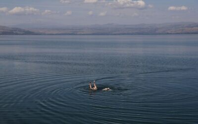 A person swims in the Sea of Galilee in northern Israel, May 4, 2020. (Menahem Kahana/AFP via Getty Images)