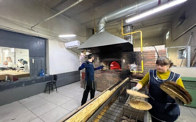 A factory worker makes shmura matzah under supervision in Ukraine. (Courtesy of Meyer Stambler)