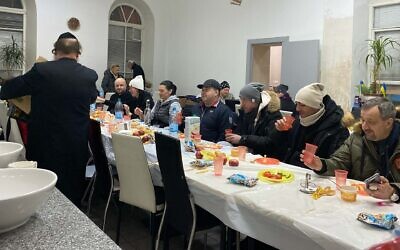 Ukrainian refugees enjoy a meal at the Agudath Israel synagogue in Chisinau, Moldova. (Jacob Judah)