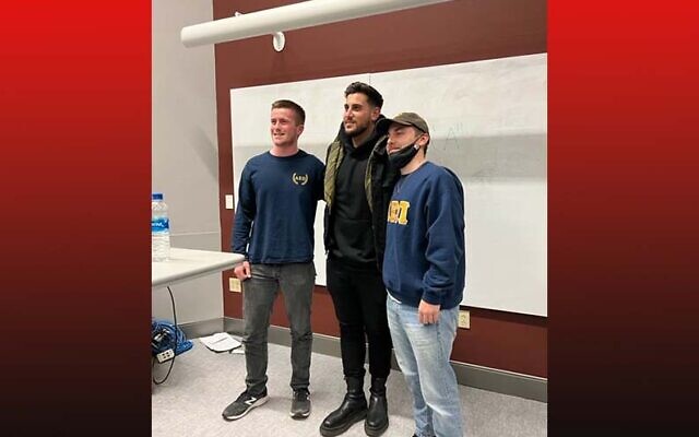 Aepi brothers Ben Szydlow (left) and Riley Crow (right) pose with Rudy Rochman. Photo provided by Chabad at Pitt.