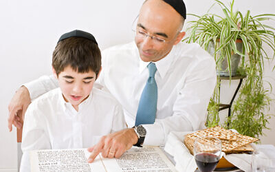 Reading the haggadah together is one of several Passover customs. Photo by pushlama via iStock.
