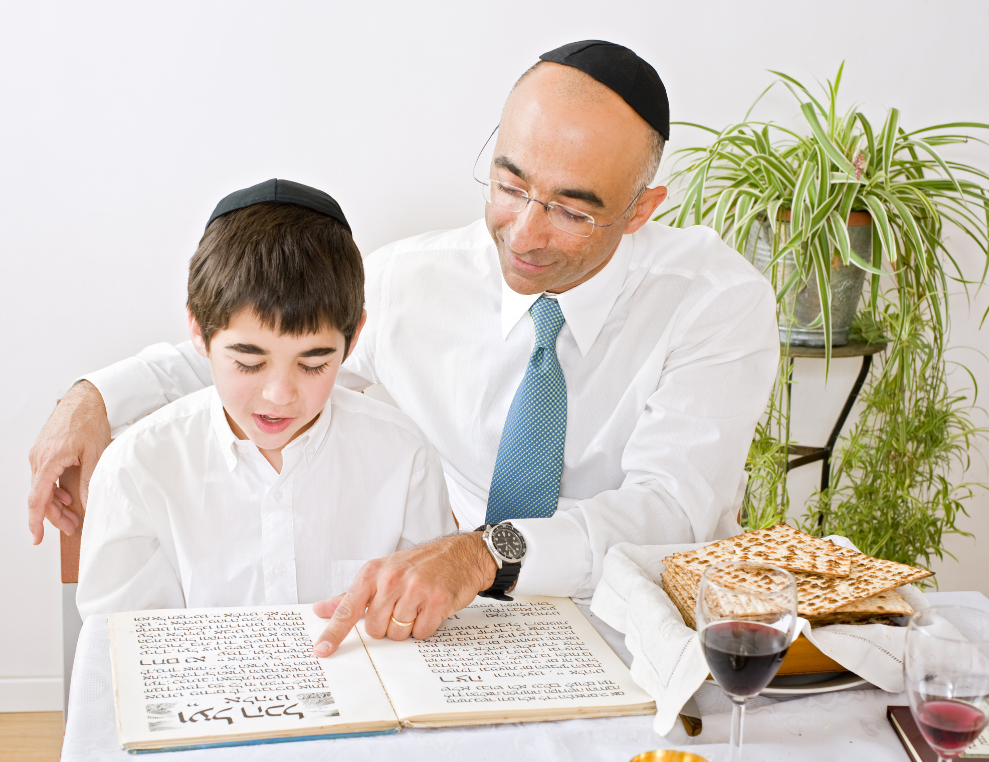 Reading the haggadah together is one of several Passover customs. Photo by pushlama via iStock.