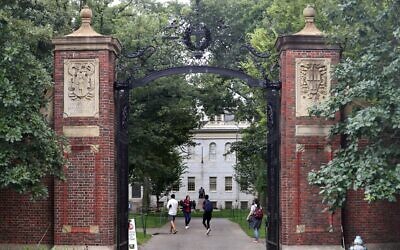 Students walk by the Harvard Yard gate in Cambridge, MA, Sep. 16, 2021. (David L. Ryan/The Boston Globe via Getty Images)
