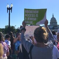 A protester holds up a sign reading "Abortion Access is a Jewish Value" at a rally in front of the US Capitol Building organized by the National Council of Jewish Women, May 17, 2022. (Julia Gergely)