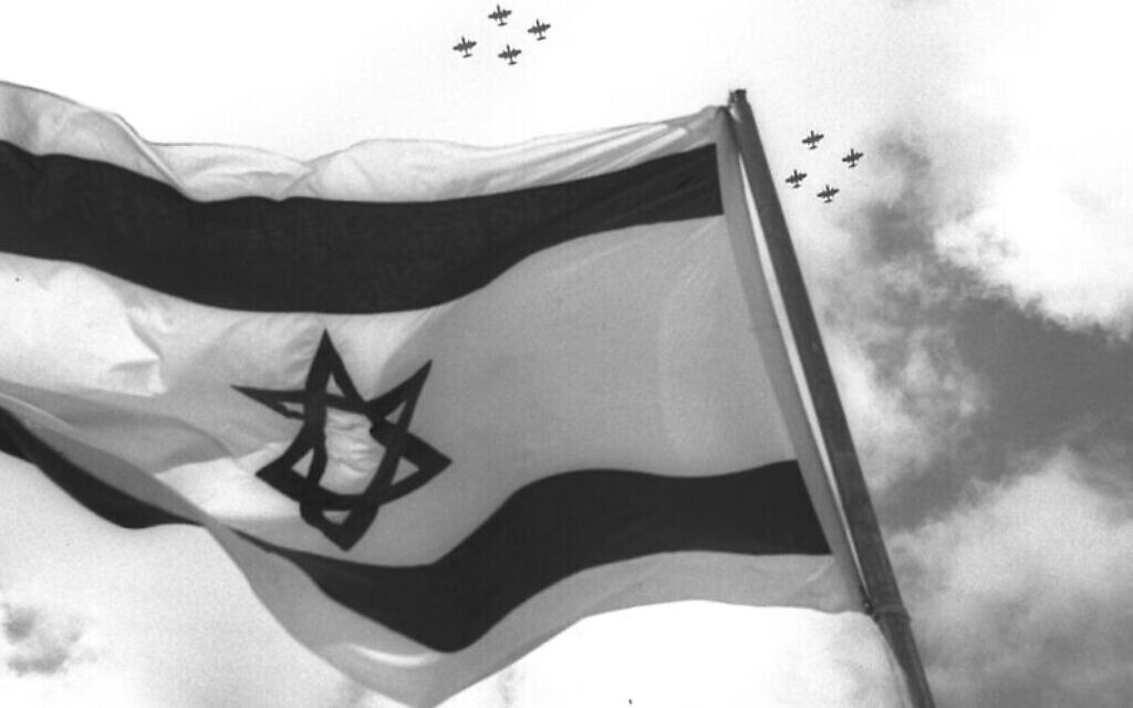 Fighter jets fly over the Israeli flag on Independence Day celebrations in 1957. (Photo by Moshe Pridan/Government Press Office)