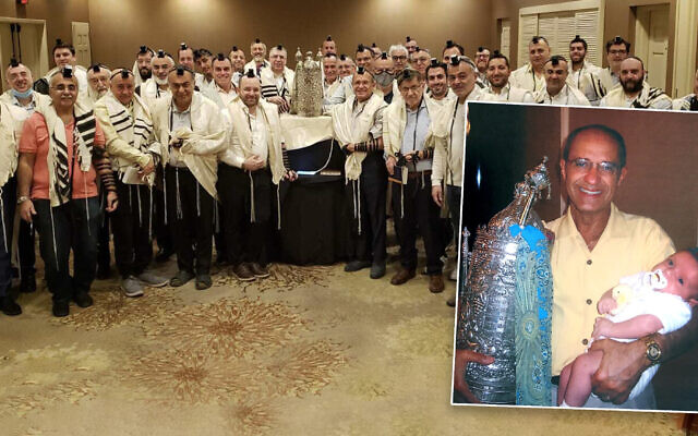 Jack Abraham with his family Torah, which has been used by his family and the Jewish community around the world for almost two decades. (Courtesy)