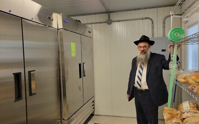 Rabbi Moishe Vogel stands inside in front of the new freezer and refrigeration units inside the new Shifra Shed. Photo by David Rullo.